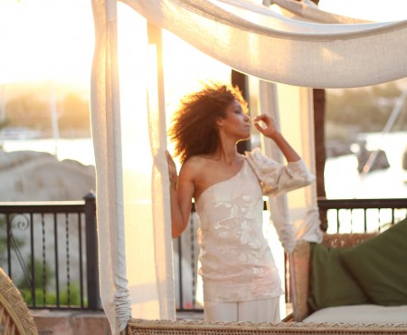The Global Girl Travels: Ndoema sports a beige on beige one shoulder silk blouse with silk palazzo wide leg pants and gold pyramid cuff at the The Sofitel Legend Old Cataract Hotel in Aswan, Egypt.